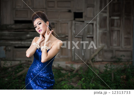 Beautiful lady in luxury blue dress with pearl 12313733