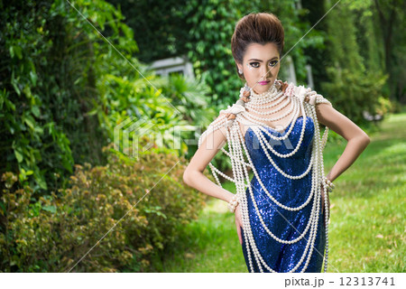 Beautiful lady in luxury blue dress with pearl 12313741