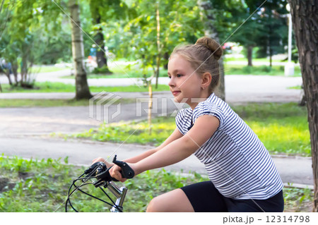 Cute girl driving bicycle in summer 12314798