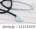 Stethoscope on Cardiogram 12315429