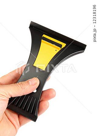 Scraper in hand on white background. 12318196