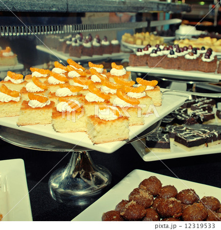 Dessert bar with assorted fruit and chocolate sweets. 12319533