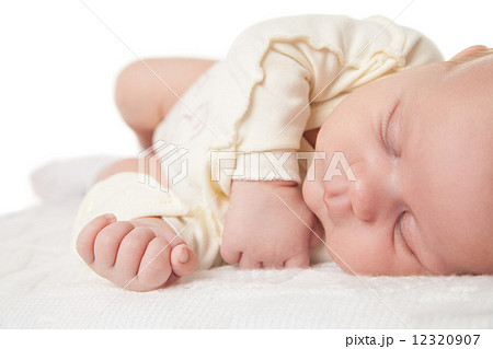 Peaceful baby lying on bed while sleeping 12320907