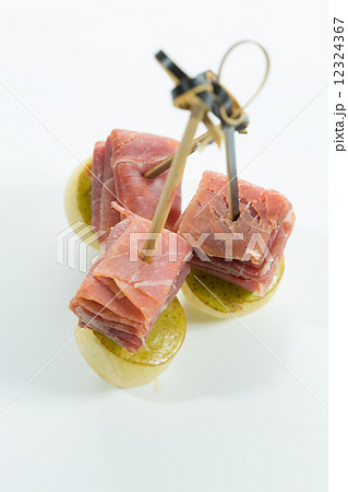 Appetizer. Creative cuisine. Prosciutto with pear on a white background. 12324367
