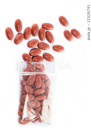 Red Medical pills spilling out of a medicine Plastic zipper bag 12326741