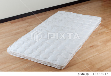 thin mattress on wooden floor 12328017