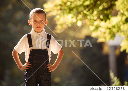 Cute smiling young boy backlit by the sun 12328228