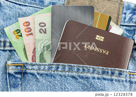 Closeup of credit card and passport in jeans in blue denim jeans Closeup of credit card and passport in jeans in blue denim jeans 12328378