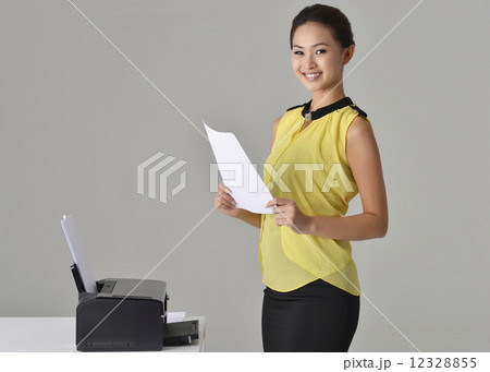 Asian Office Lady printing out documnet 12328855