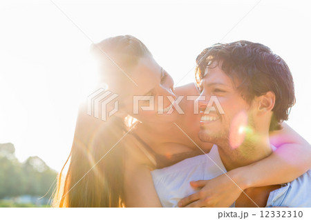 Tourist couple in city park walking piggyback 12332310