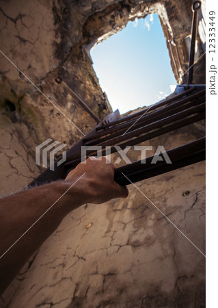 Grungy interior with old ladder, blue sky in the end and hand Grungy interior with old ladder, blue sky in the end and hand 12333449