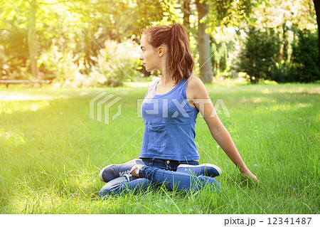 teenage girl doing yoga in nature teenage girl doing yoga in nature 12341487
