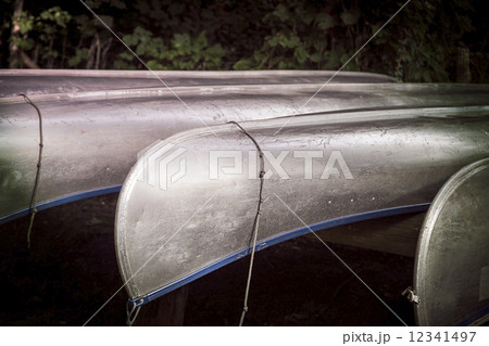 some aluminium canoes resting, with strong vignette 12341497