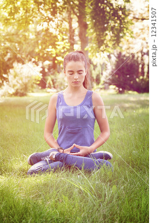 beautiful teenage girl meditates in nature 12341507