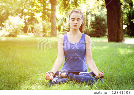 beautiful teenage girl meditates in nature 12341508
