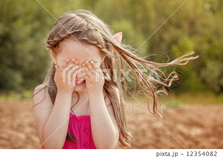 Cute little girl playing hide and seek with camera 12354082