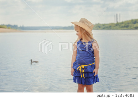 Funny blonde girl posing on background of lake 12354083