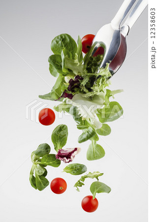 fresh salad falling from a clamp 12358603