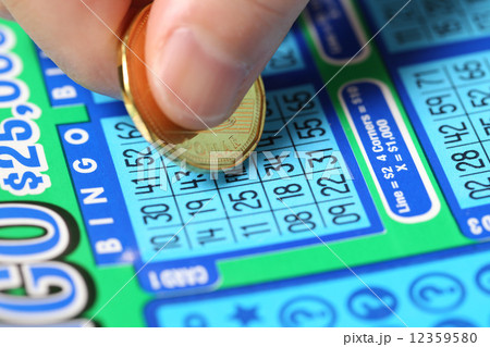 Woman scratching lottery ticket called Bingo.  12359580