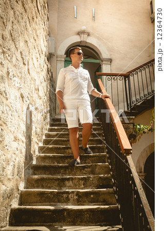 man walking down the old stone staircase at sunny day man walking down the old stone staircase at sunny day 12364730