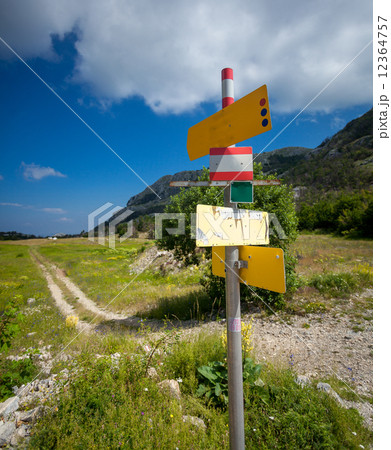 signpost with different directions standing on start of tourist 12364757