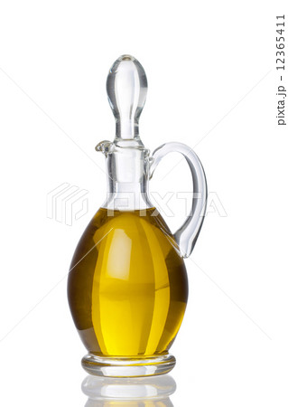 Glass carafe with olive oil and real reflection 12365411