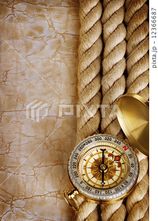 Compass and rope on vintage old paper background Compass and rope on vintage old paper background 12366687