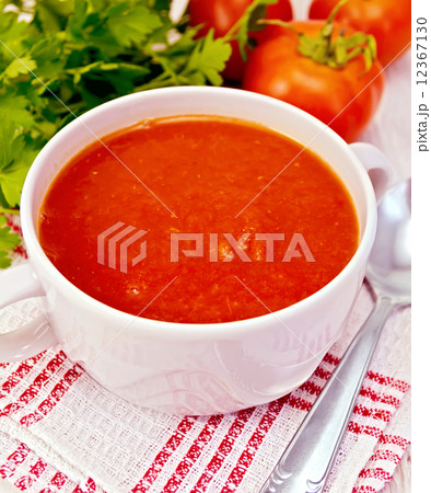Soup tomato on napkin with spoon Soup tomato on napkin with spoon 12367130