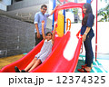 Asian Family with daughter at play on playground slide.  12374325