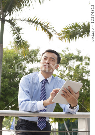 Business executive in a park. 12374813