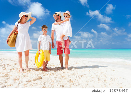 Family on a tropical beach vacation 12378447