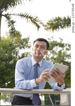 Business executive in a park. 12378546