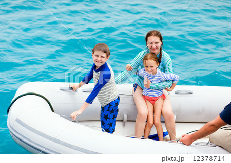 Family in inflatable dinghy boat 12378714