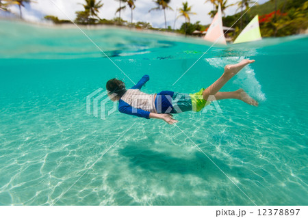 Little boy swimming in ocean 12378897