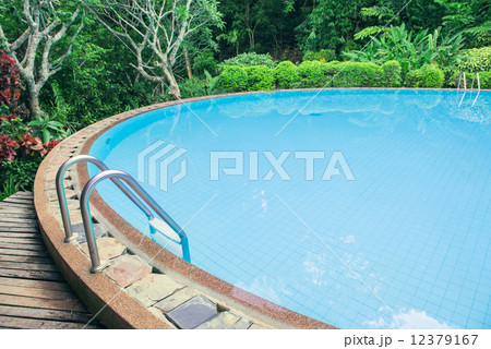 Swimming pool with stair in the green garden 12379167