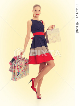 Beautiful girl with shopping bags. Pin-up style. 12379403