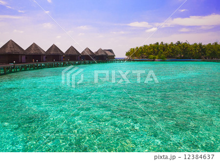 Maldives. Island in ocean and  overwater villas . 12384637