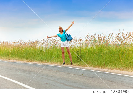 Hitchhiking girl votes on road Hitchhiking girl votes on road 12384902