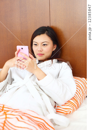 Young Women, Home, Resort, Hotel, apartment, Condo, Lifestyle, playful, siting, bed, mobile, blanket Young Women, Home, Resort, Hotel, apartment, Condo, Lifestyle, playful, siting, bed, mobile, blanket 12385847