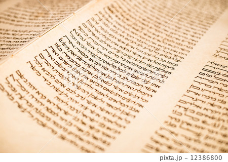 The Hebrew handwritten Torah, on a synagogue alter, with Kippah and Talith 12386800
