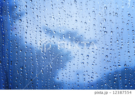 close up texture of water drop background on blue mirror use as 12387554