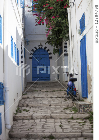 Narrow street with moped in Sidi Bou Said, Tunisia 12394798
