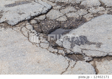 Hole in street asphalt Hole in street asphalt 12402171