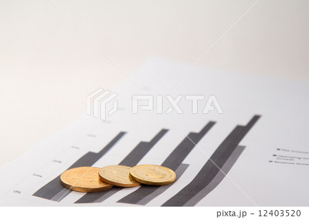Gold coins on financial chart Gold coins on financial chart 12403520