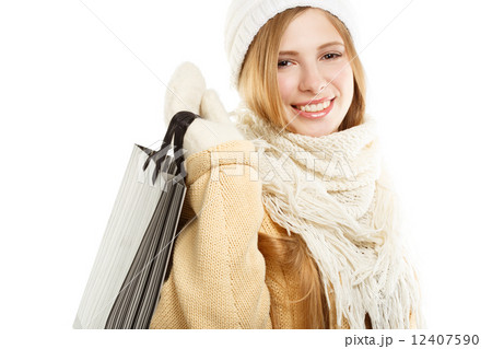 Smiling woman in warm clothing with bag Smiling woman in warm clothing with bag 12407590