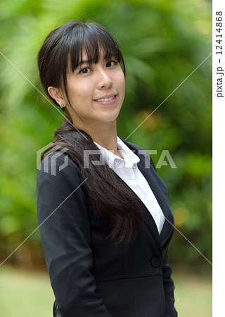 Portrait of one successful chinese business woman in suit in front of greenery Portrait of one successful chinese business woman in suit in front of greenery 12414868