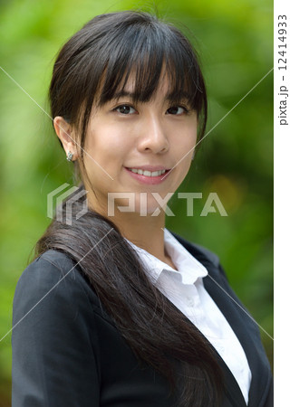 Portrait of one successful chinese business woman in suit in front of greenery Portrait of one successful chinese business woman in suit in front of greenery 12414933
