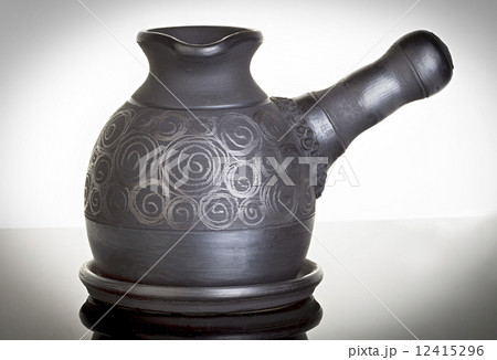 Ceramic, clay cezve on black background 12415296
