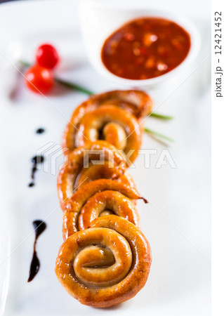 organic grilled sausages on a white plate. organic grilled sausages on a white plate. 12421452