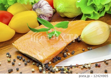 Salmon with peppers and various vegetables around  12424905